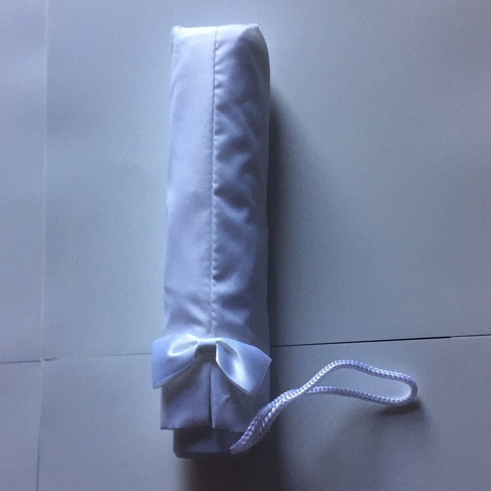 Umbrella wedding white with a small bow.